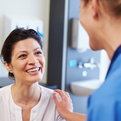 shutterstock_317573531-min Female Patient Being Reassured By Doctor In Hospital Room